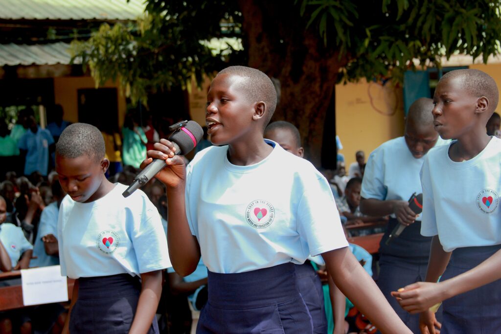 I girl speaks into a microphone at the International Day of the Girl celebrations in Nimule, South Sudan