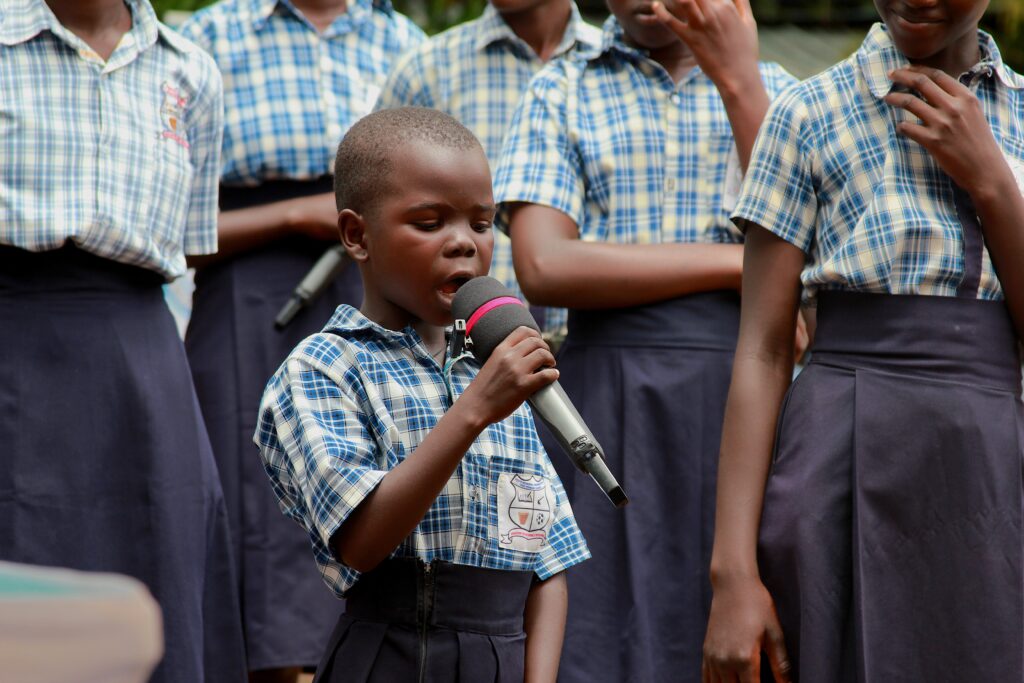 A young girl speaks on the microphone at an International Day of the Girl event in Nimule, South Sudan