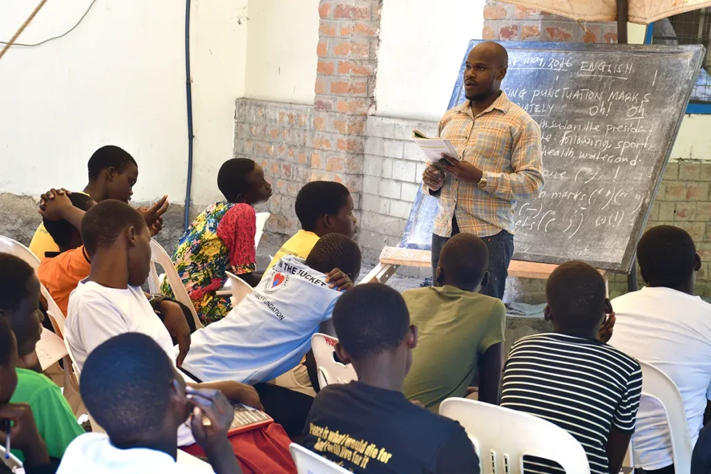 A teacher talking to a group of students during class at a school in Niumle South Sudan